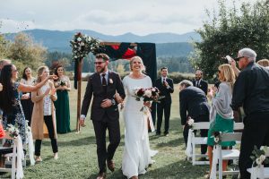 bride and groom walking down the aisle after getting married