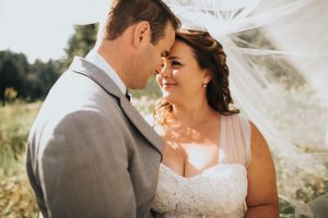 wedding couple kissing under veil